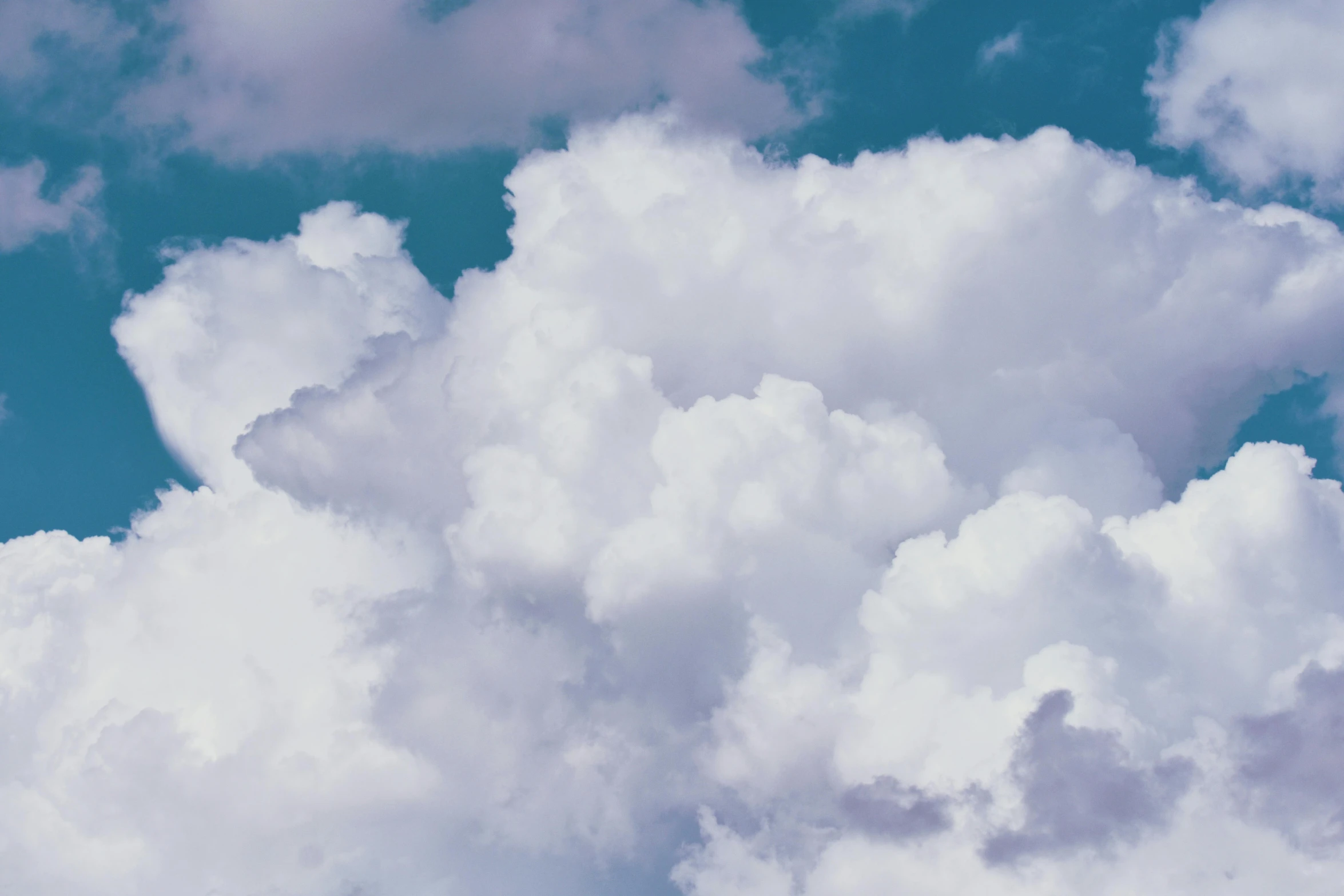 a plane flying through a cloudy blue sky, an album cover, unsplash, magic realism, cumulus, profile image, close-up photo, multiple stories