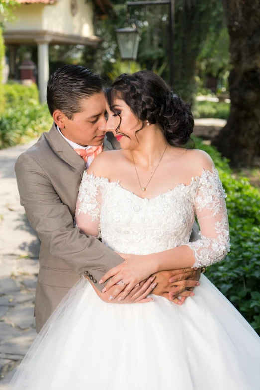 a man and a woman standing next to each other, a portrait, pexels contest winner, romanticism, tlaquepaque, wearing a wedding dress, square, embracing