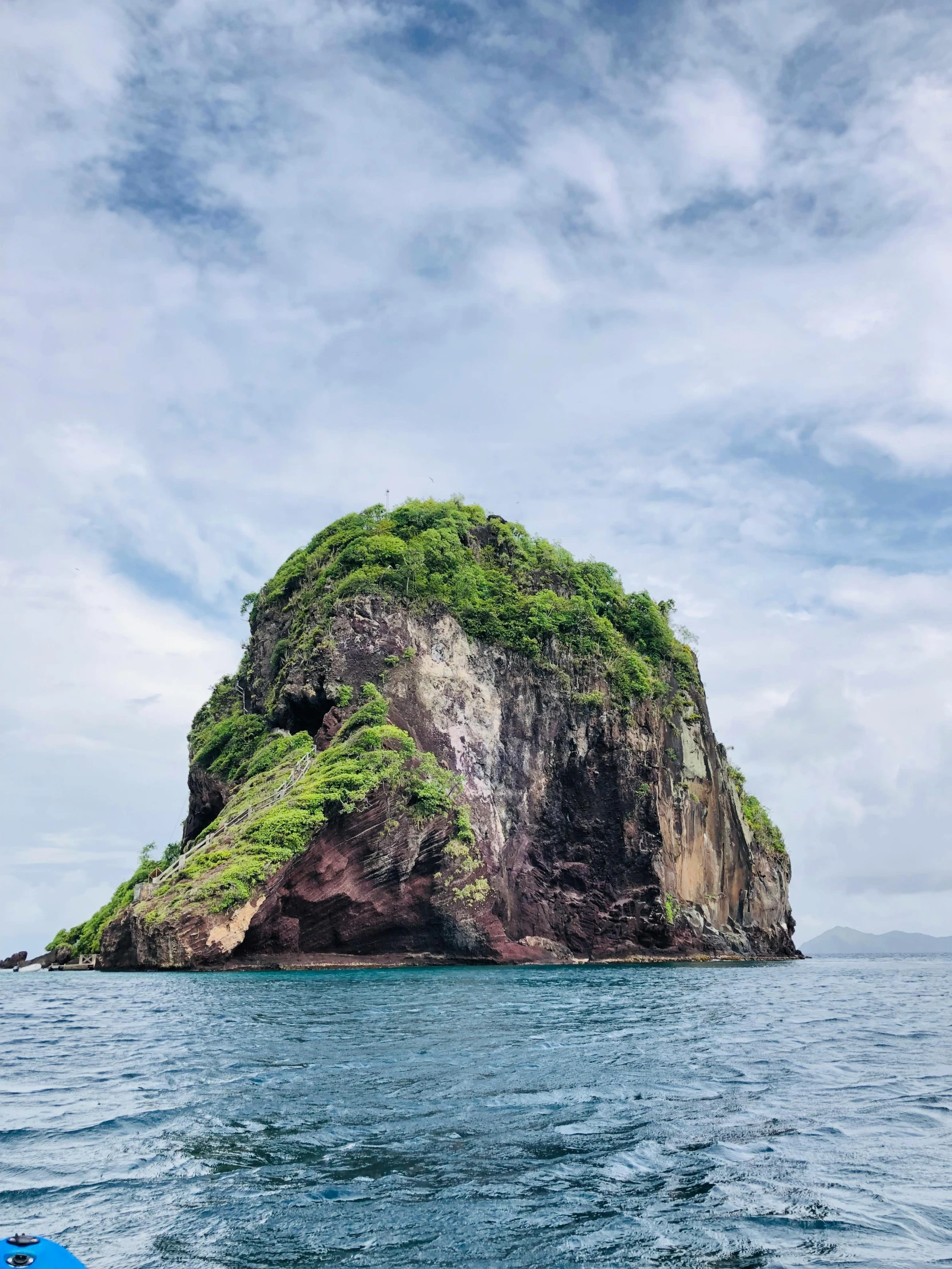 a small island in the middle of the ocean, by Rachel Reckitt, pexels contest winner, renaissance, rugged face, covered with vegetation, big sharp rock, high light on the left