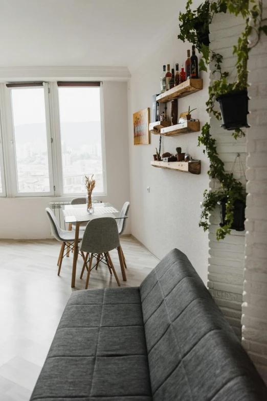a living room filled with furniture next to a window, unsplash contest winner, light and space, small kitchen, romanian, low quality photo, white wall