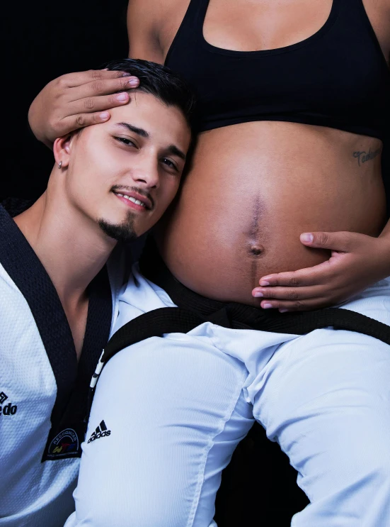a man and a woman pose for a picture, featured on reddit, pregnant belly, capoeira, close up half body shot, advertising photo