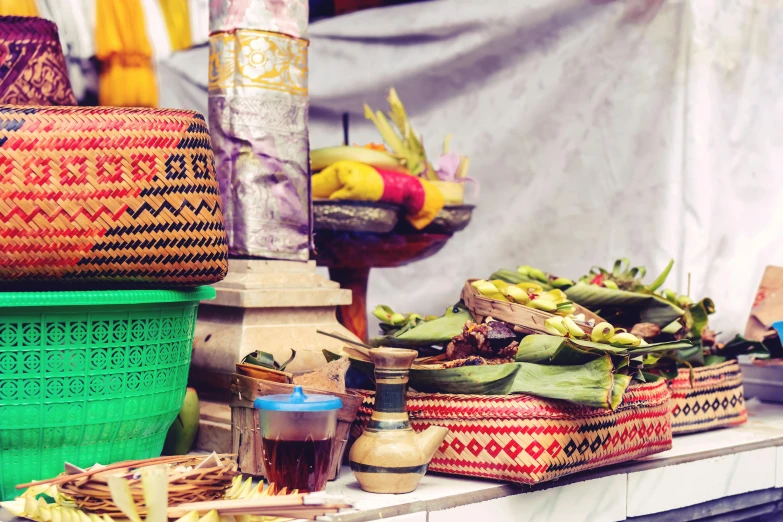 a bunch of baskets sitting on top of a table, by Daniel Lieske, trending on unsplash, sumatraism, colourful biomorphic temple, cloth accessories, avatar image