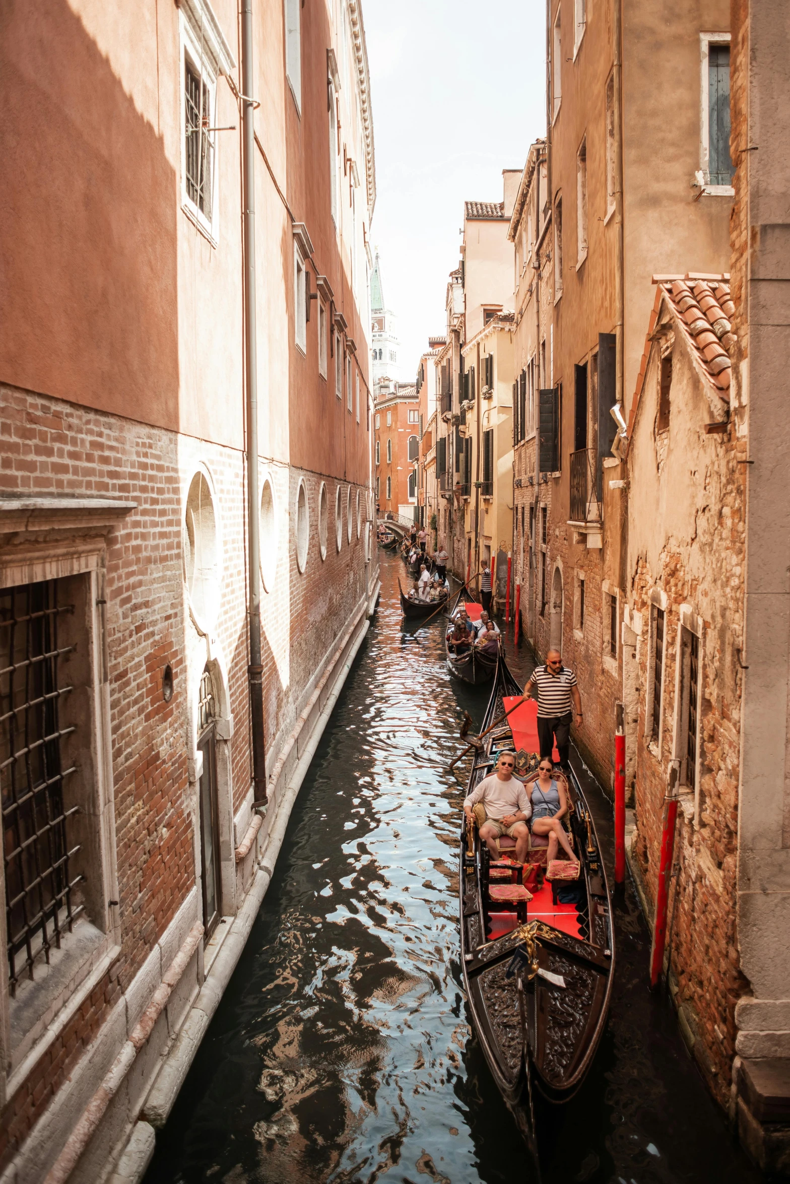 a canal filled with lots of boats next to tall buildings, pexels contest winner, renaissance, fantasy. gondola boat, shady alleys, venetian red, 2022 photograph