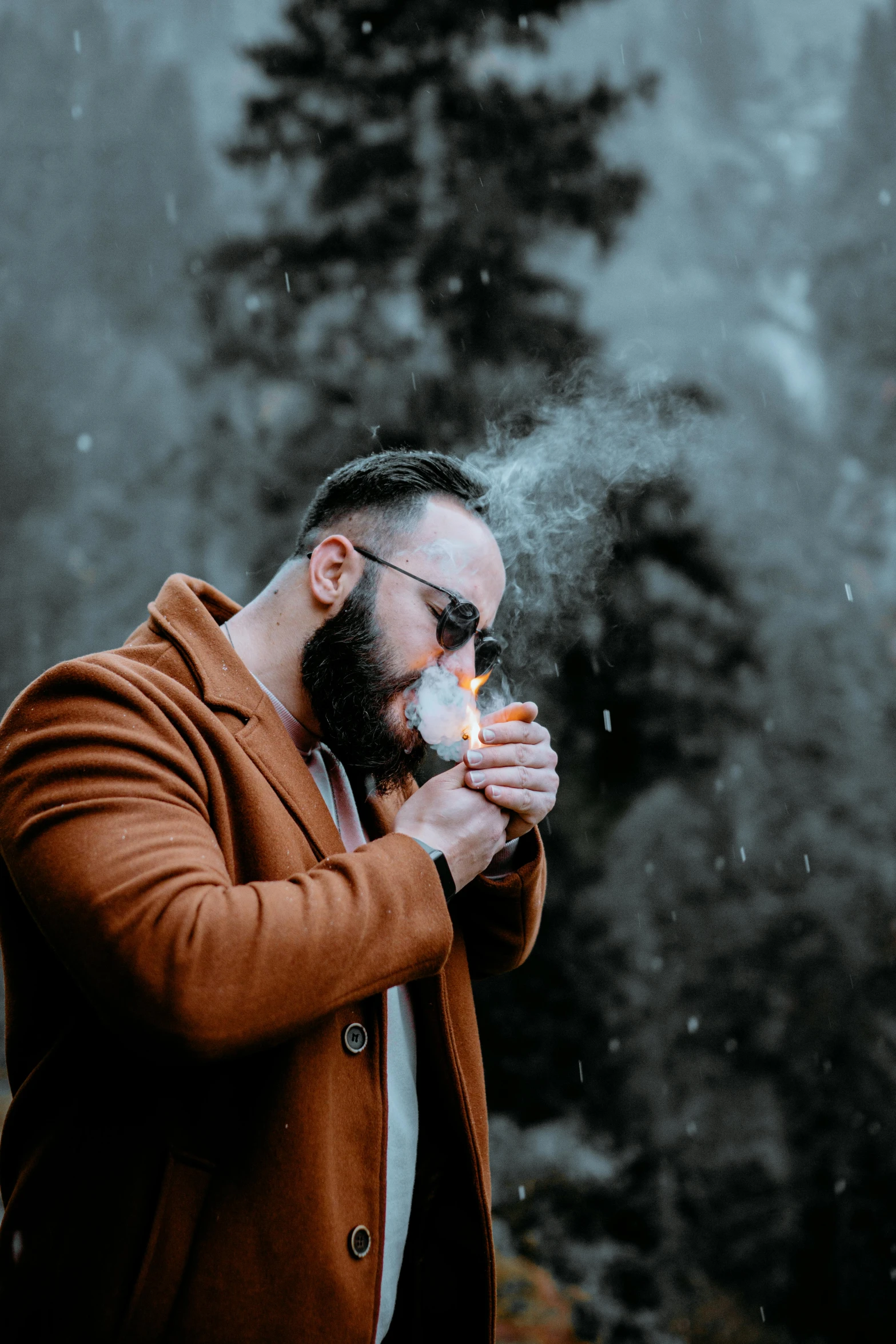 a man with a beard smoking a cigarette, a photo, pexels contest winner, cold as ice! 🧊, smokey cannons, he is wearing a brown sweater, 2019 trending photo