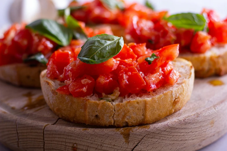 a wooden cutting board topped with slices of bread covered in tomato sauce, renaissance, profile image, bizzaro, caparisons, basil