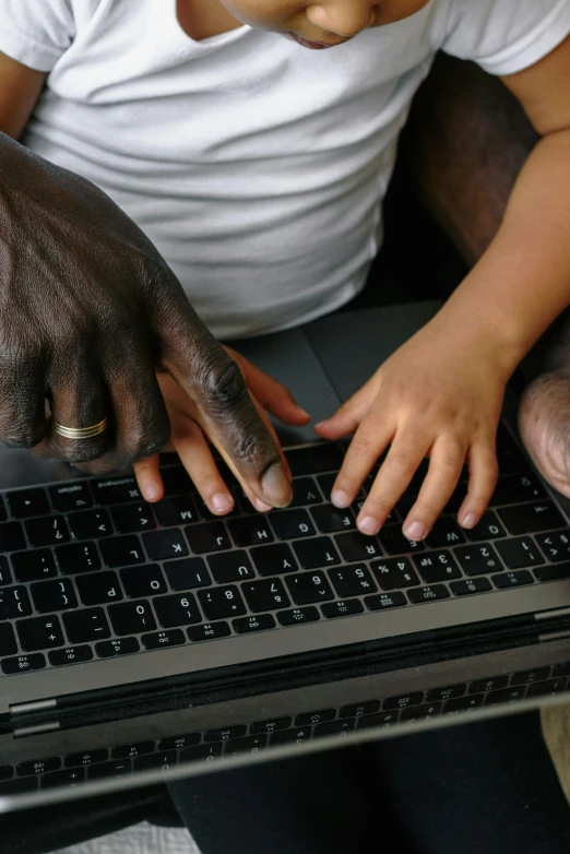 a man and a child using a laptop computer, by Daren Bader, pexels, panel of black, enhanced hands, acronym, photograph credit: ap