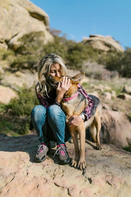 a woman sitting on a rock with a dog, brandi love, peak experience ”, may), profile image