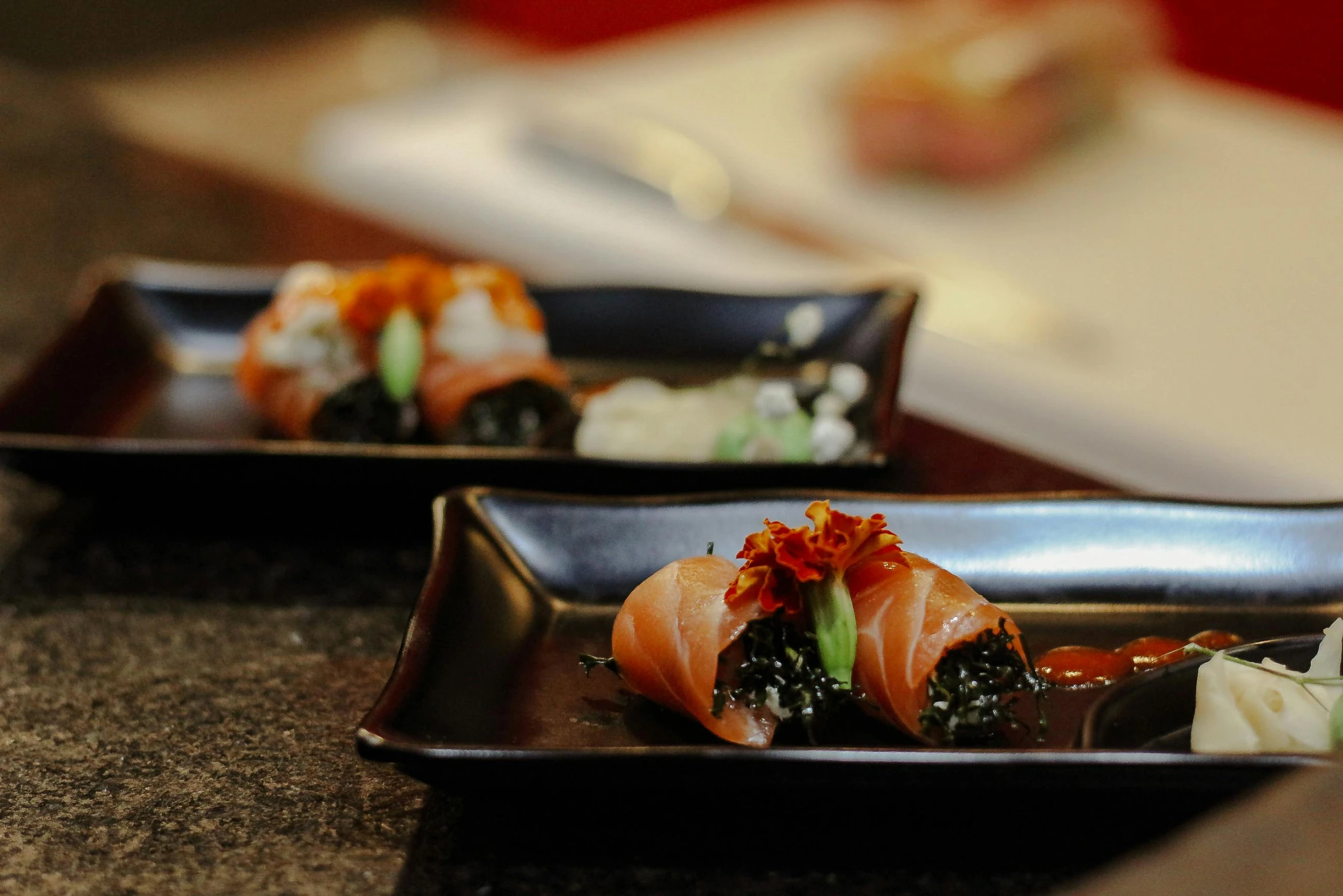 a close up of a plate of food on a table, inspired by Maki Haku, unsplash, mingei, black, 15081959 21121991 01012000 4k