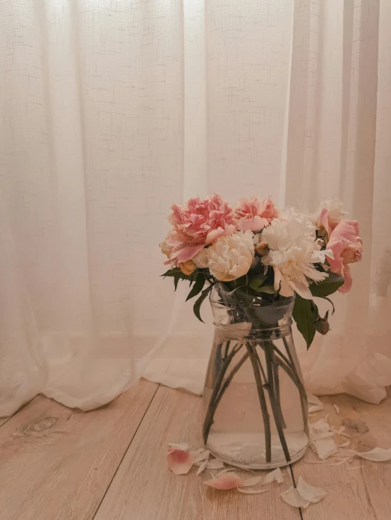 a vase filled with pink and white flowers, a still life, trending on unsplash, romanticism, ethereal curtain, transparent cloth, cottagecore!!, low quality photo