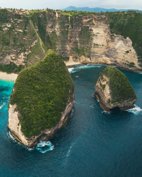 two large rocks in the middle of a body of water, by Daniel Lieske, pexels contest winner, sumatraism, bird's-eye view, massive arch, panoramic, lesbians