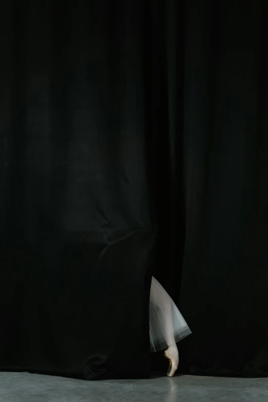 a woman standing in front of a black curtain, by Thomas Wijck, unsplash, hyperrealism, hiding, photographed for reuters, white cloth, dark illustration