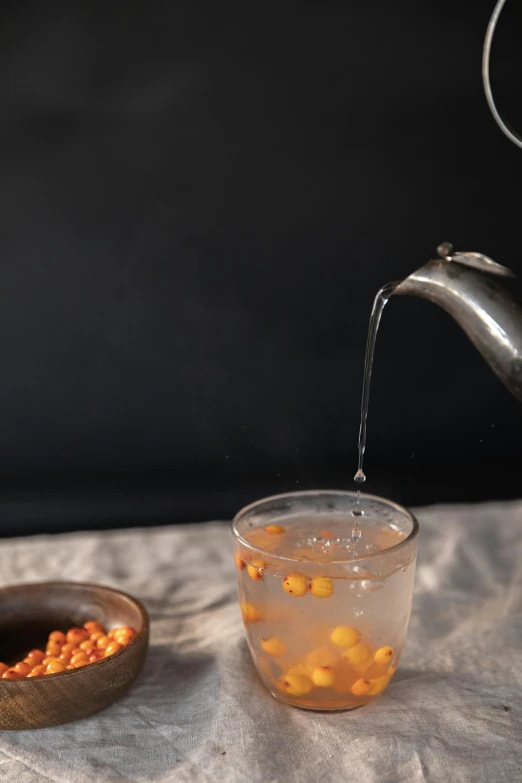 a tea pot pouring tea into a cup, a still life, inspired by Kanō Naizen, unsplash, floating bubbles, grey orange, drinking cocktail, corn