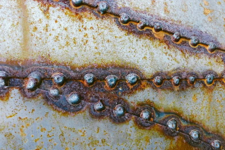 a rusted metal surface with rivets and rivets, a macro photograph, by Adam Marczyński, pexels, large chain, water stains, stainless steal, made of wax and metal