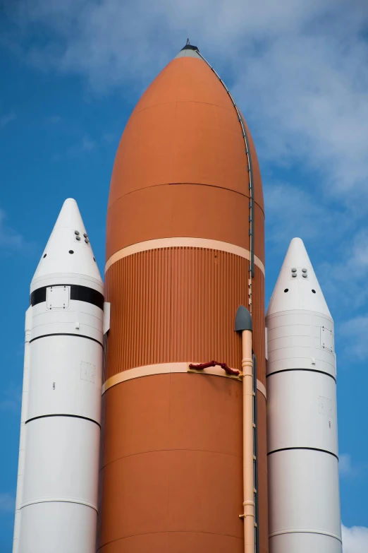 a red and white rocket sitting on top of a building, renaissance, orange, atlantis, close - up photograph, vessels