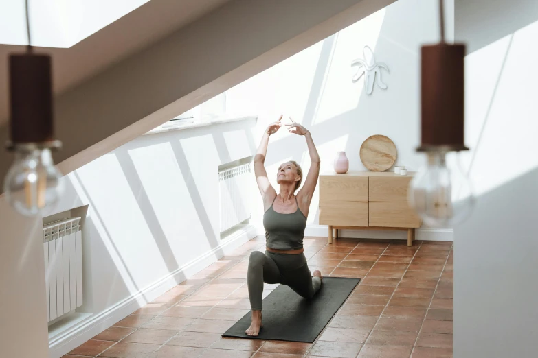 a woman doing a yoga pose on a mat, pexels contest winner, light and space, low ceiling, manuka, low quality photo, high picture quality