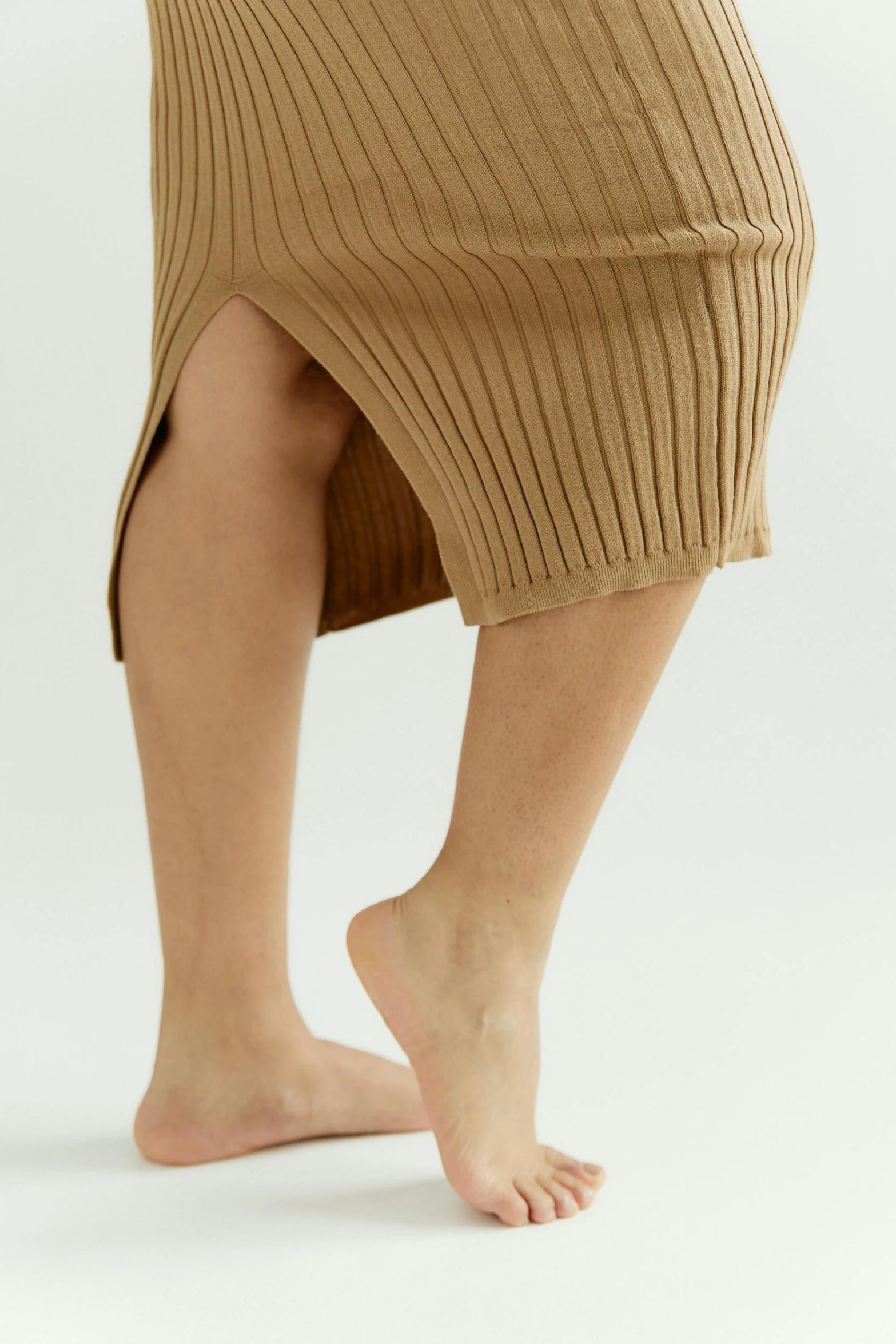 a close up of a person wearing a skirt, smooth tan skin, head to toe, ultrawide image, product shot