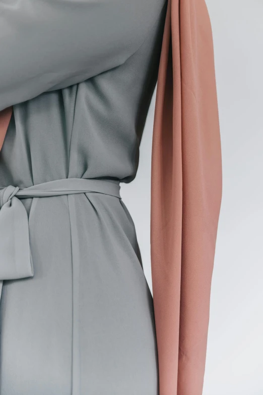 a woman wearing a gray dress and a pink scarf, an album cover, inspired by Jakob Emanuel Handmann, trending on pexels, jumpsuit, detail shot, modest flowing gown, muted colors. ue 5