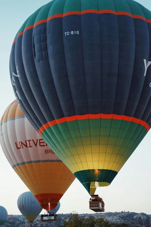 a couple of hot air balloons that are flying in the sky, by Jan Tengnagel, happening, up close image, buenos aires, vessels, at twilight