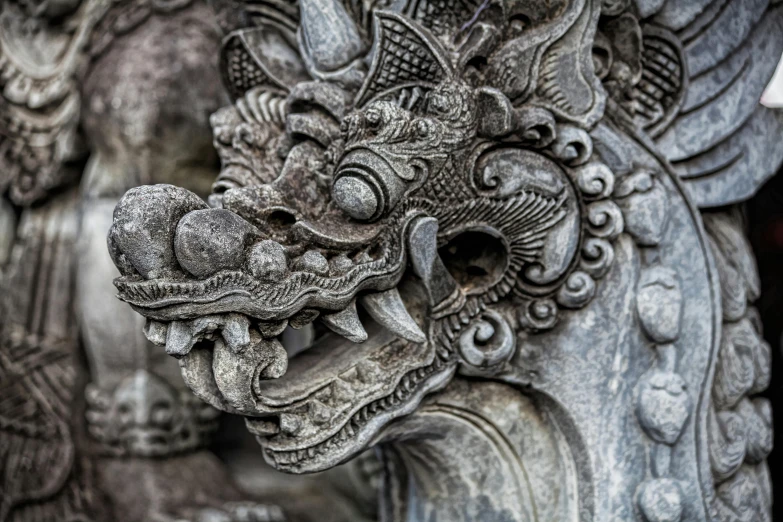 a close up of a statue of a dragon, by Adam Marczyński, pexels contest winner, sumatraism, intricate faces, bali, stone sculpture, hyperdetailed metalwork