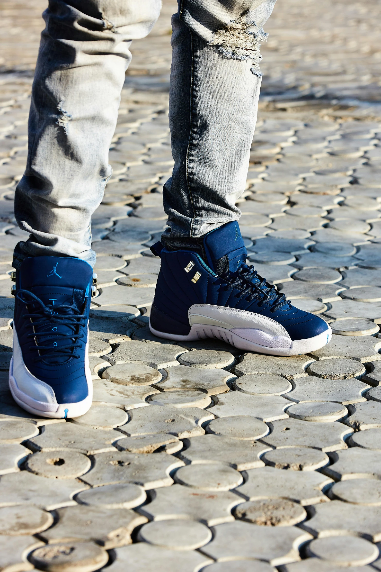 a person standing on a sidewalk with a skateboard, a digital rendering, trending on unsplash, renaissance, navy blue armor, sneaker, standing on rocky ground, blue and white