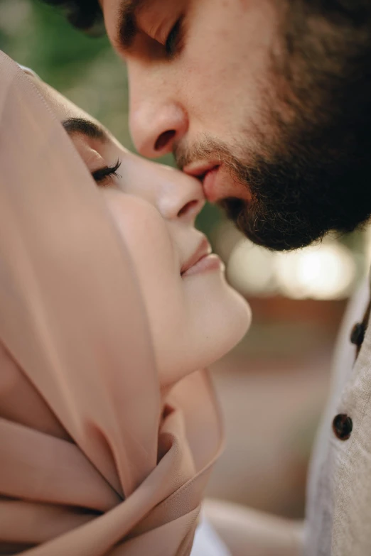 a man kissing a woman wearing a hijab, neck zoomed in from lips down, square, high-quality photo, brown