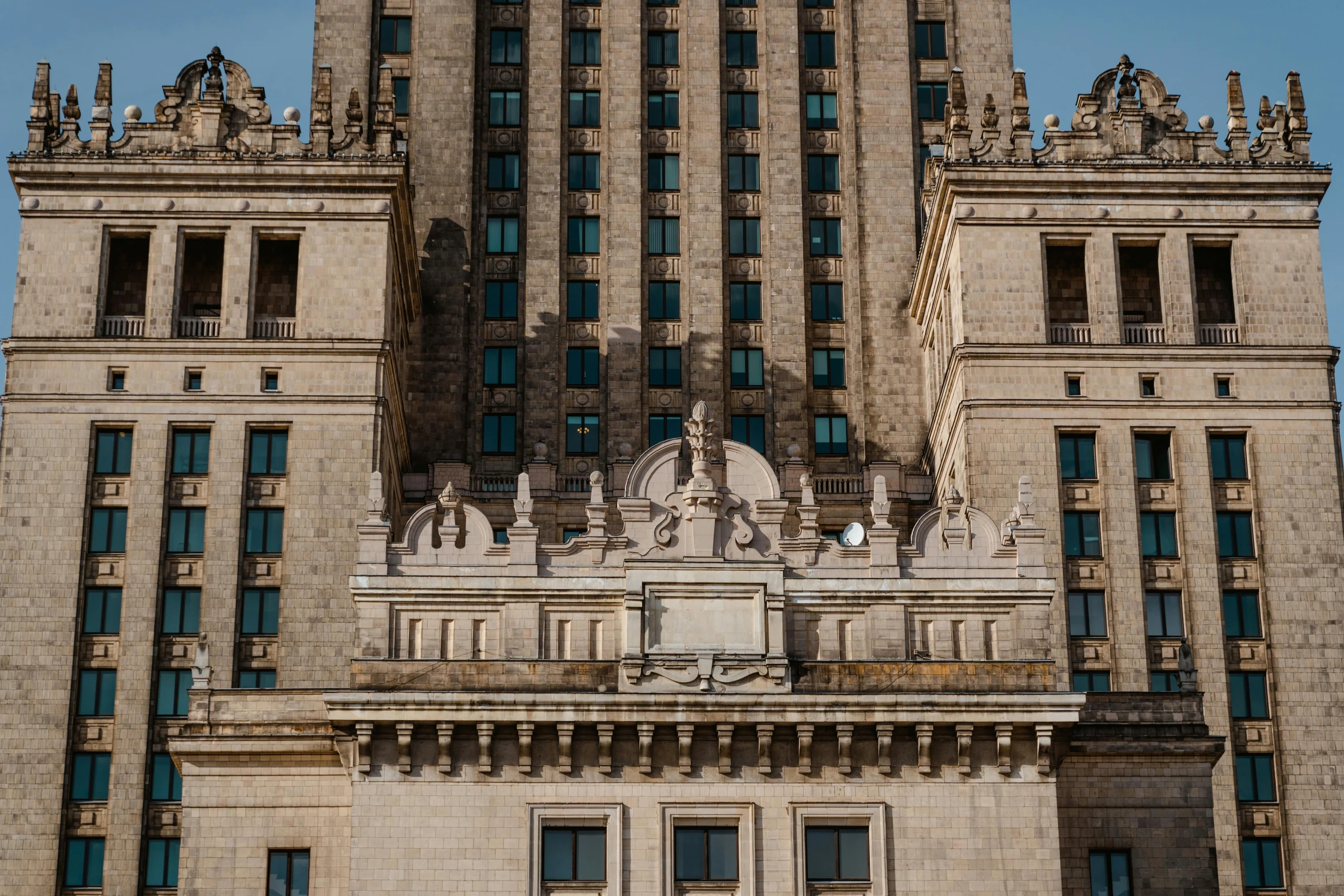 a tall building with a clock on top of it, by Adam Marczyński, pexels contest winner, socialist realism, buildings carved out of stone, art - deco style, frontal view, rostov