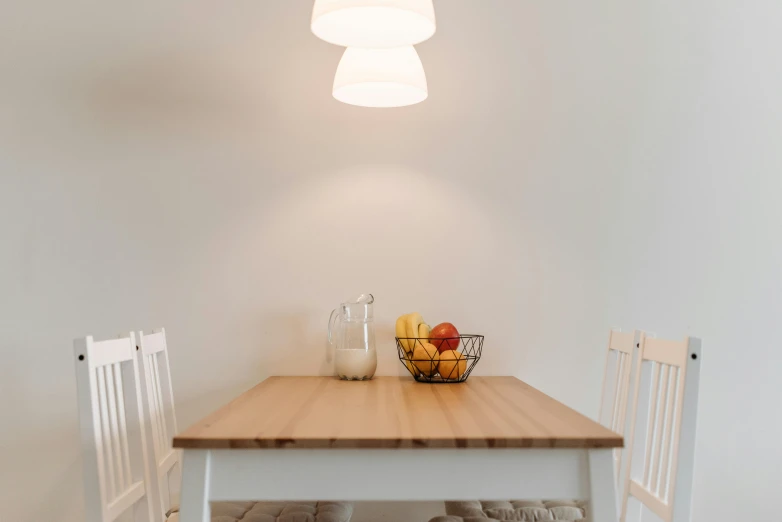 a table with a bowl of fruit on top of it, pexels contest winner, light and space, white accent lighting, 3 light sources, scandinavian, neat and tidy