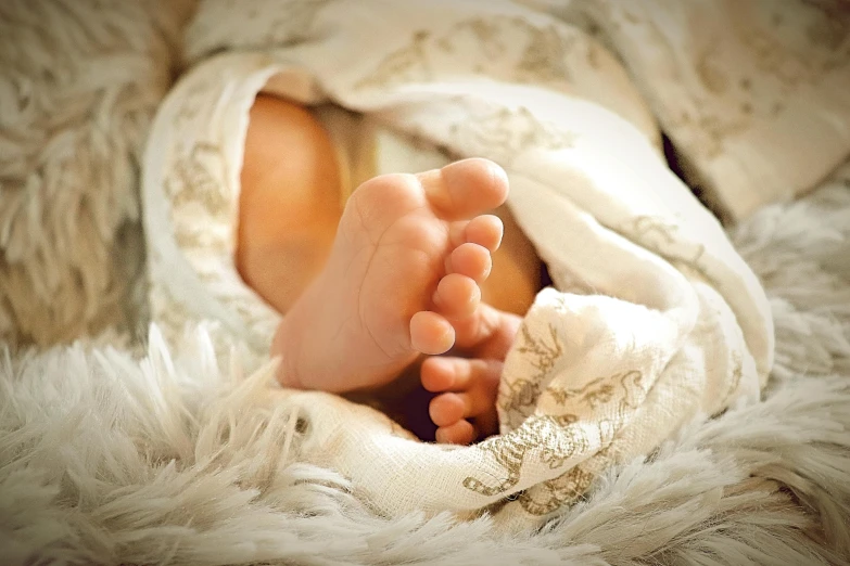 a close up of a person's feet under a blanket, pixabay, renaissance, human babies, fetus, full body close-up shot, a radiant