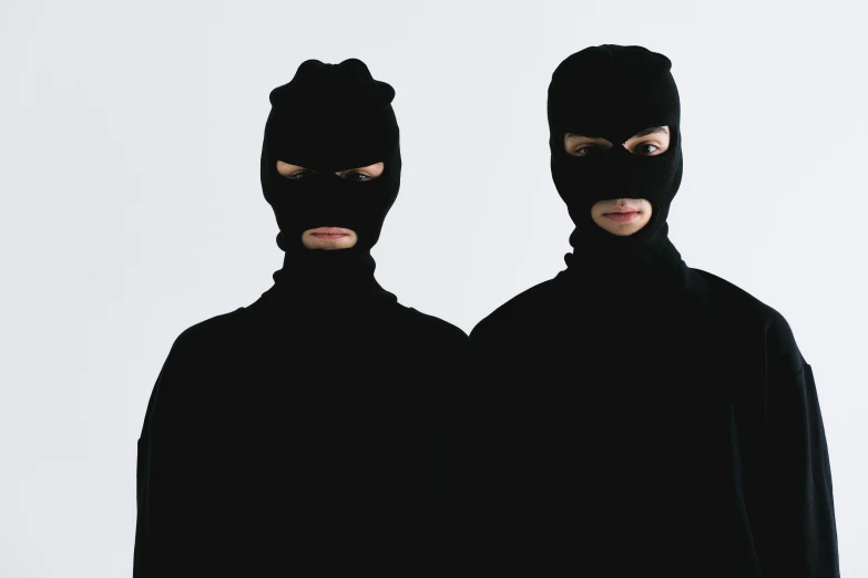 two people dressed in black standing next to each other, an album cover, unsplash, antipodeans, balaclava, twins, robbery, jung gi kim