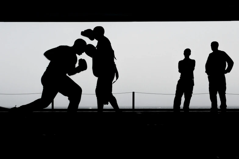 a group of people standing next to each other, by Joze Ciuha, pexels contest winner, figuration libre, sparring, silhouette of a man, training, [ realistic photography ]