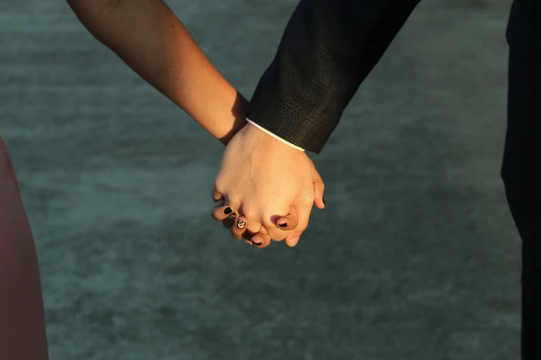 a close up of two people holding hands, an album cover, trending on pexels, 15081959 21121991 01012000 4k, modeled, deep colour, well - dressed