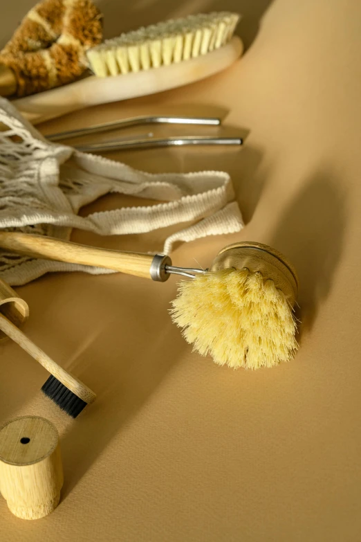a bunch of brushes sitting on top of a table, sustainable materials, slide show, yellow, bath