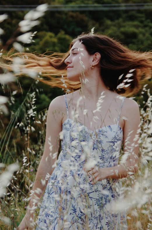 a woman standing in a field of tall grass, happening, swirling around, profile image