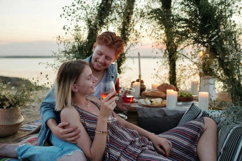 a man and woman sitting next to each other on a blanket, pexels contest winner, renaissance, eating outside, swashbuckling and romantic, instagram post, at the waterside