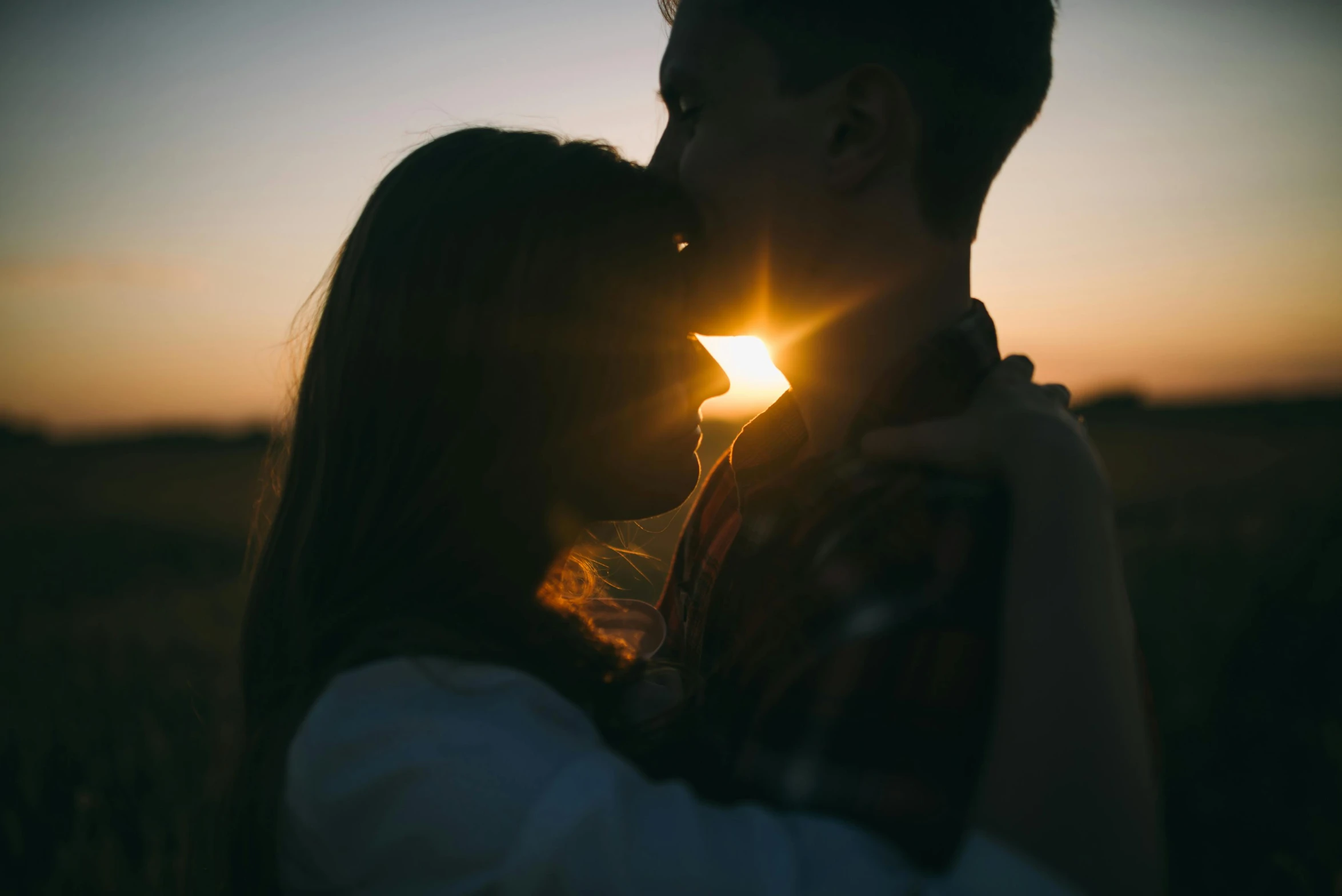 a couple kissing in a field at sunset, pexels contest winner, light glare, instagram post, 1 4 9 3, profile image