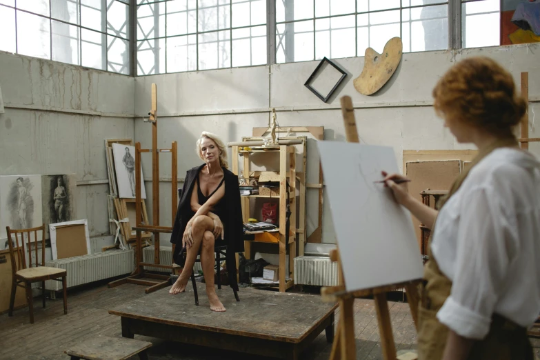 a woman sitting in a chair in an art studio, inspired by Francesco Hayez, pexels contest winner, a painting of two people, master life drawing, charlie immer and jenny saville, on a canva