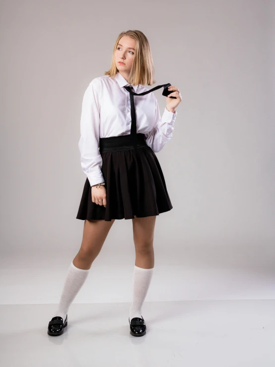 a woman in a white shirt and black skirt, unsplash, dressed as schoolgirl, 15081959 21121991 01012000 4k, plain background, wearing a shirt with a tie