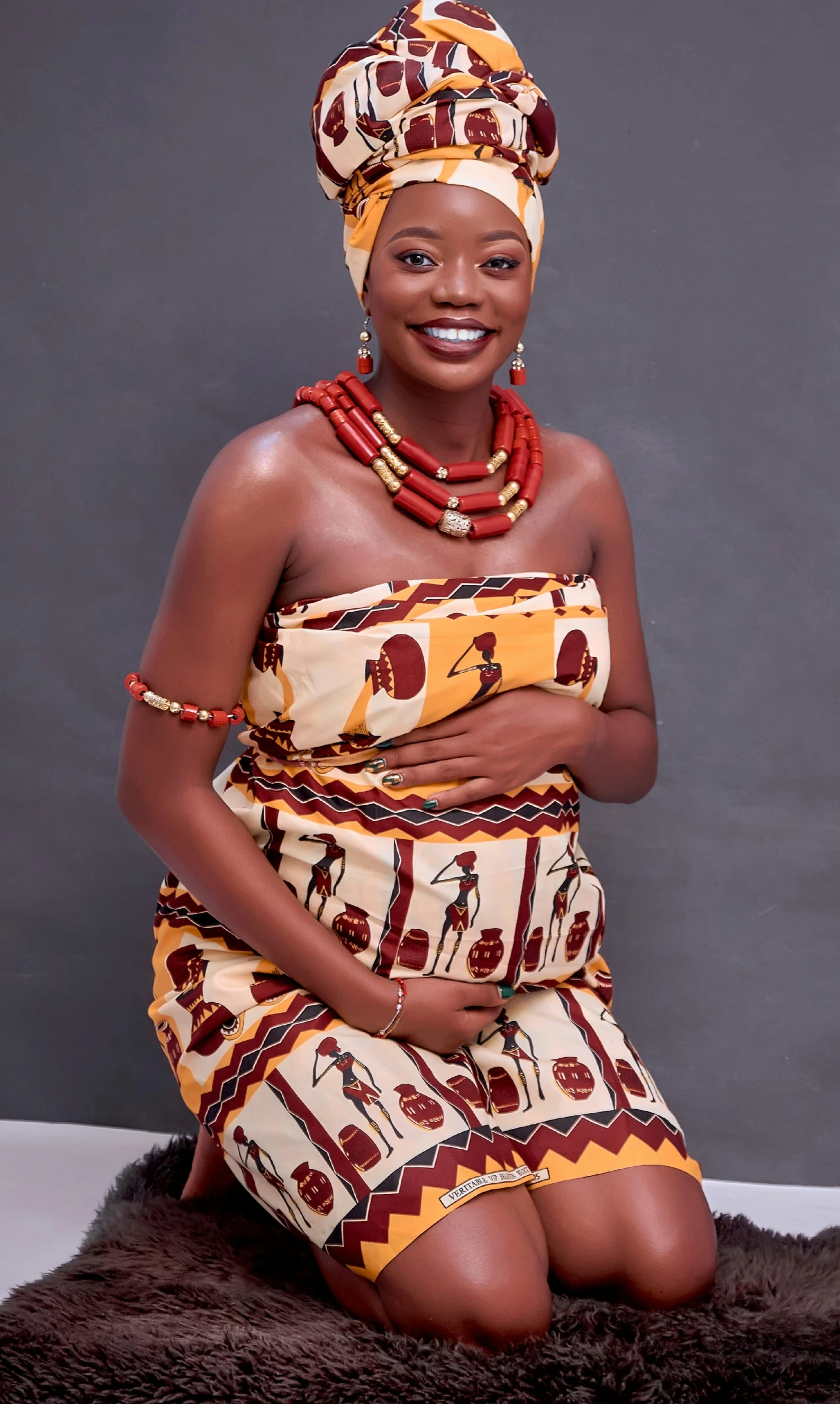 a woman sitting on top of a brown rug, by Chinwe Chukwuogo-Roy, pexels, dau-al-set, traditional dress, pregnant, plain background, 15081959 21121991 01012000 4k