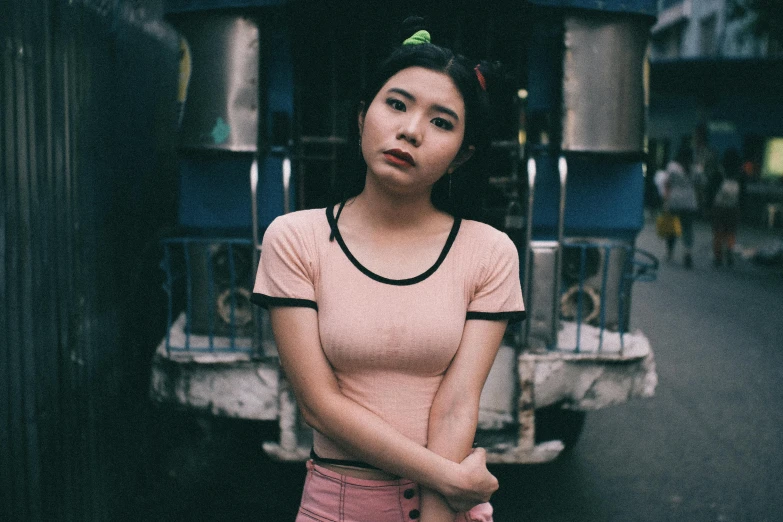 a woman standing in front of a truck, inspired by Elsa Bleda, pexels contest winner, realism, young cute wan asian face, pink shirt, crop top, 90's color photo