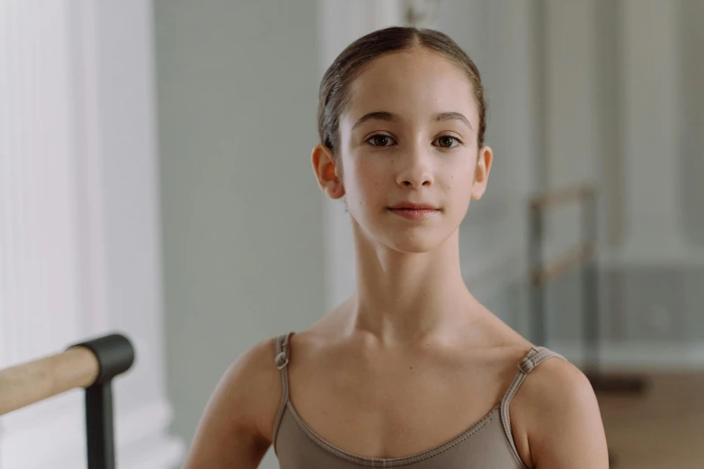 a young ballerina is posing for a picture, by Emma Andijewska, avatar image, low quality photo, medium head to shoulder shot, max dennison