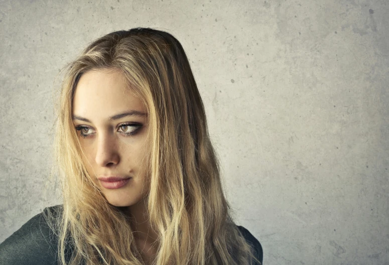 a close up of a woman with long hair, a portrait, shutterstock, dirty blonde hair, with a sad expression, instagram photo, ad image