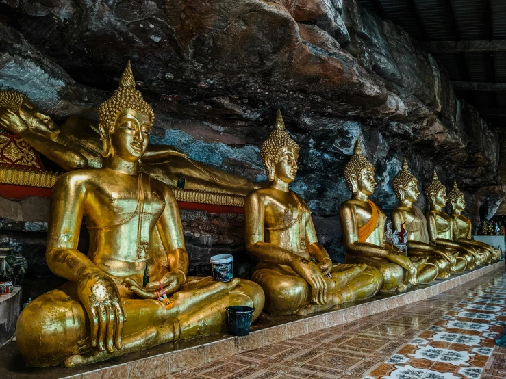 a row of golden buddha statues in a cave, pexels contest winner, ancient ruins and waterfalls, avatar image