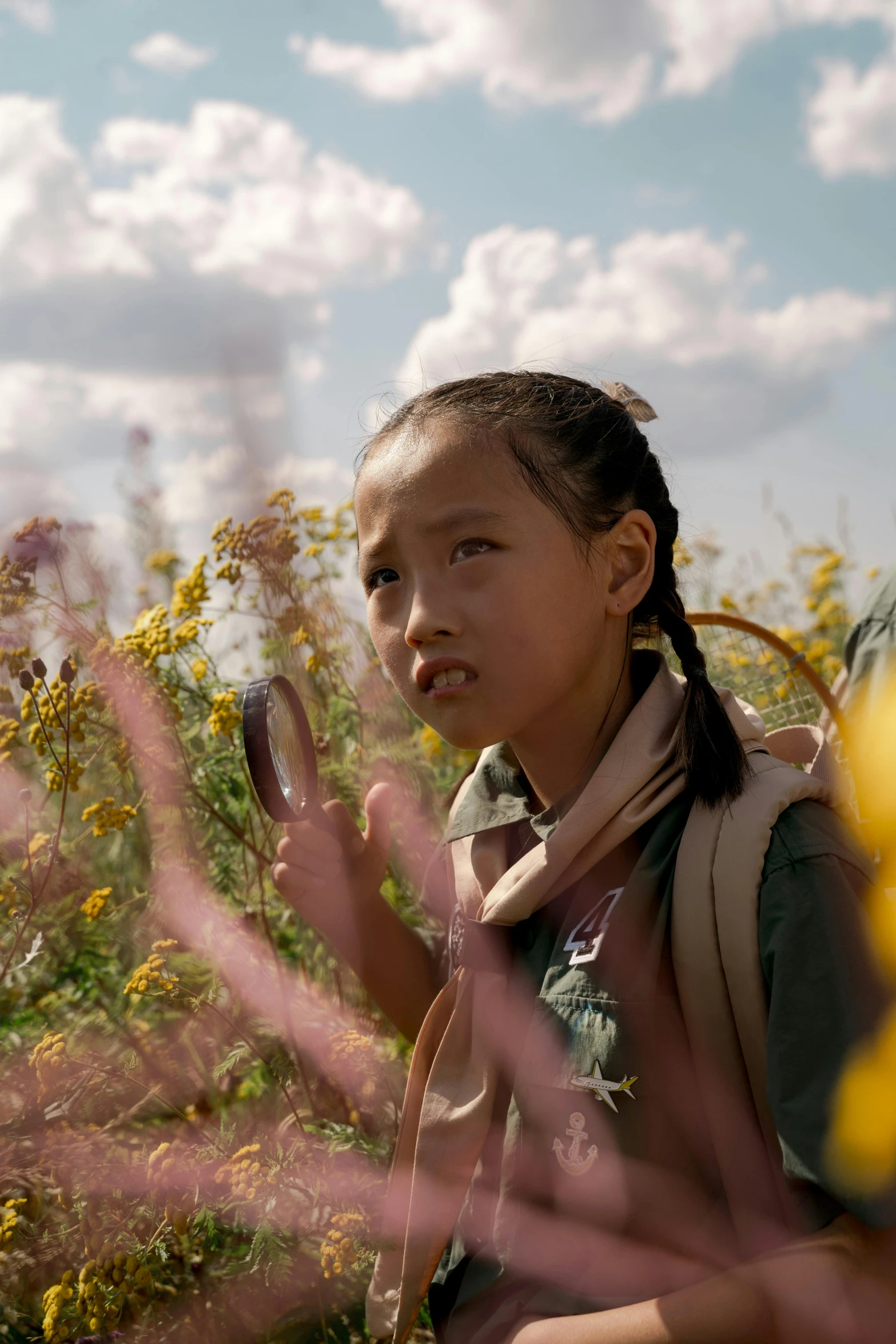 a young girl walking through a field of flowers, inspired by Gu Zhengyi, trending on unsplash, in a movie still cinematic, from marvel studios, in the steppe, kids