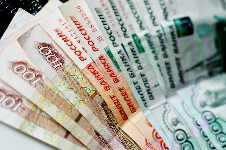 a bunch of money sitting on top of a table, by Vladimir Borovikovsky, hurufiyya, promo image, multi - coloured, middle close up, thumbnail
