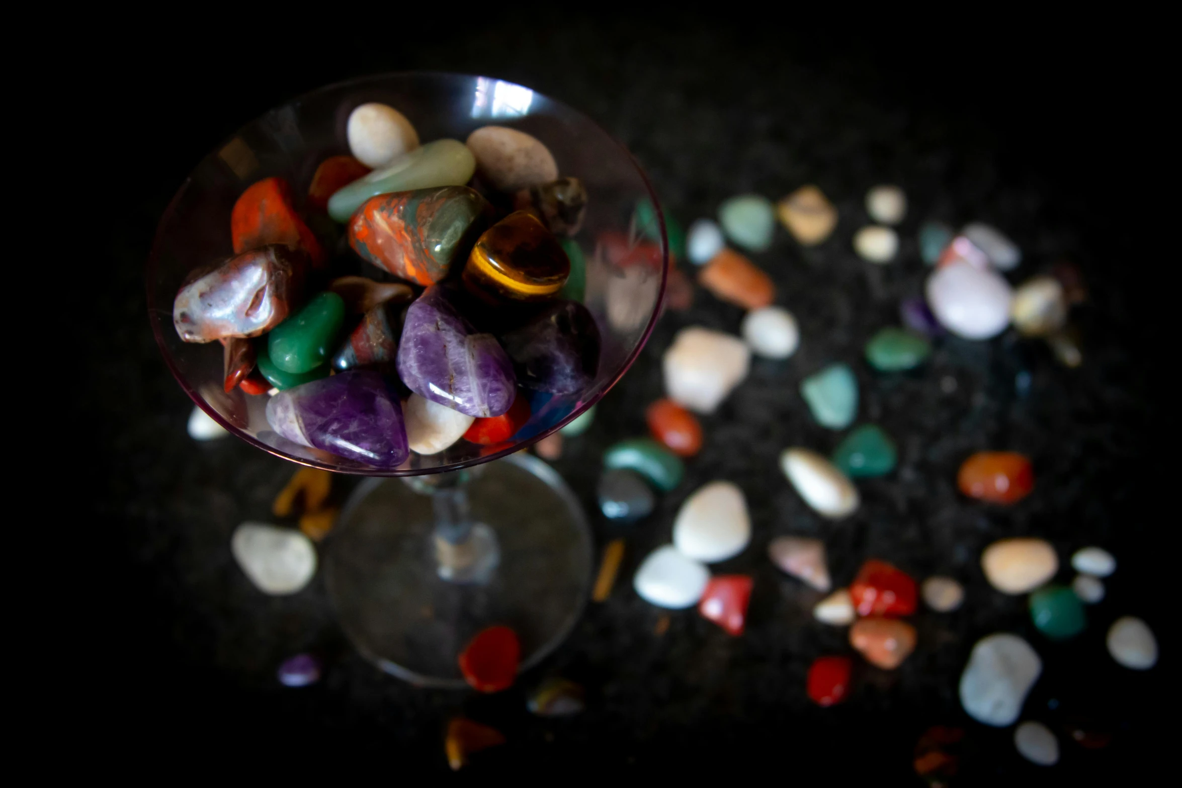 a glass filled with lots of different colored rocks, a portrait, by Jan Rustem, unsplash, fan favorite, with crystals on the walls, celebration, multi colored