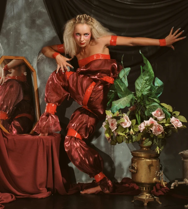 a woman dressed in red posing in front of a mirror, inspired by Karl Bryullov, baroque, die antwoord ( yolandi visser ), bouquet, 2 0 2 2, vogue