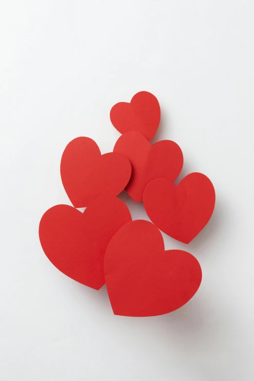 a bunch of red paper hearts on a white surface, brock hofer, ap, multiple stories, high resolution product photo