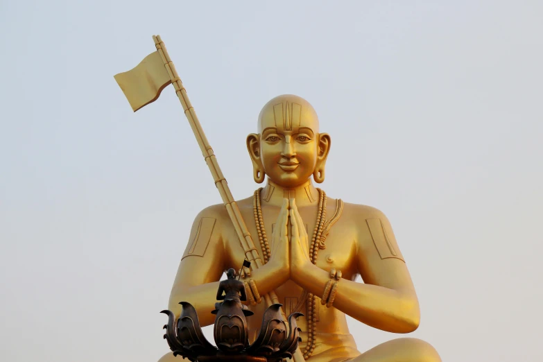 a statue of a man sitting on top of a building, a statue, inspired by Ram Chandra Shukla, pexels, samikshavad, with large golden pipes, avatar image, a bald, festivals