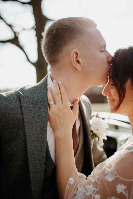 a bride and groom kissing in front of a car, neck zoomed in from lips down, winter sun, silver，ivory, thumbnail