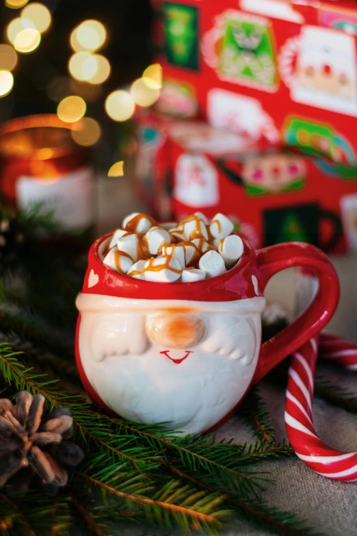 a close up of a cup of hot chocolate with marshmallows, a portrait, by Julia Pishtar, santa, caramel, official product photo, made of glazed